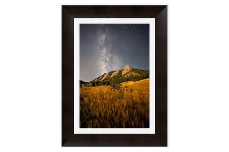 A piece of framed Boulder art shows the Flatirons in Colorado.