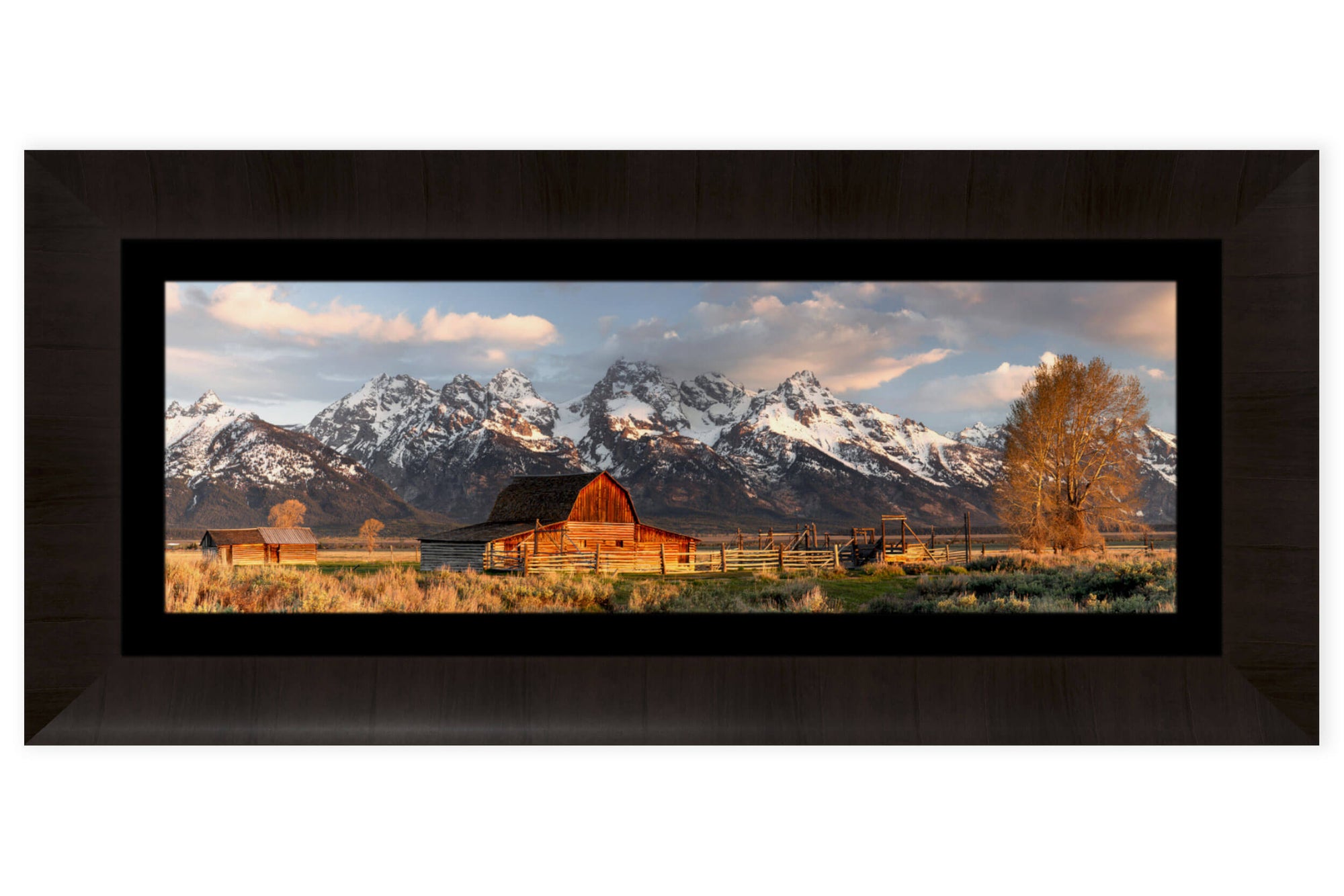 A piece of framed Jackson Hole art shows the barns at Mormon Row in Grand Teton National Park.