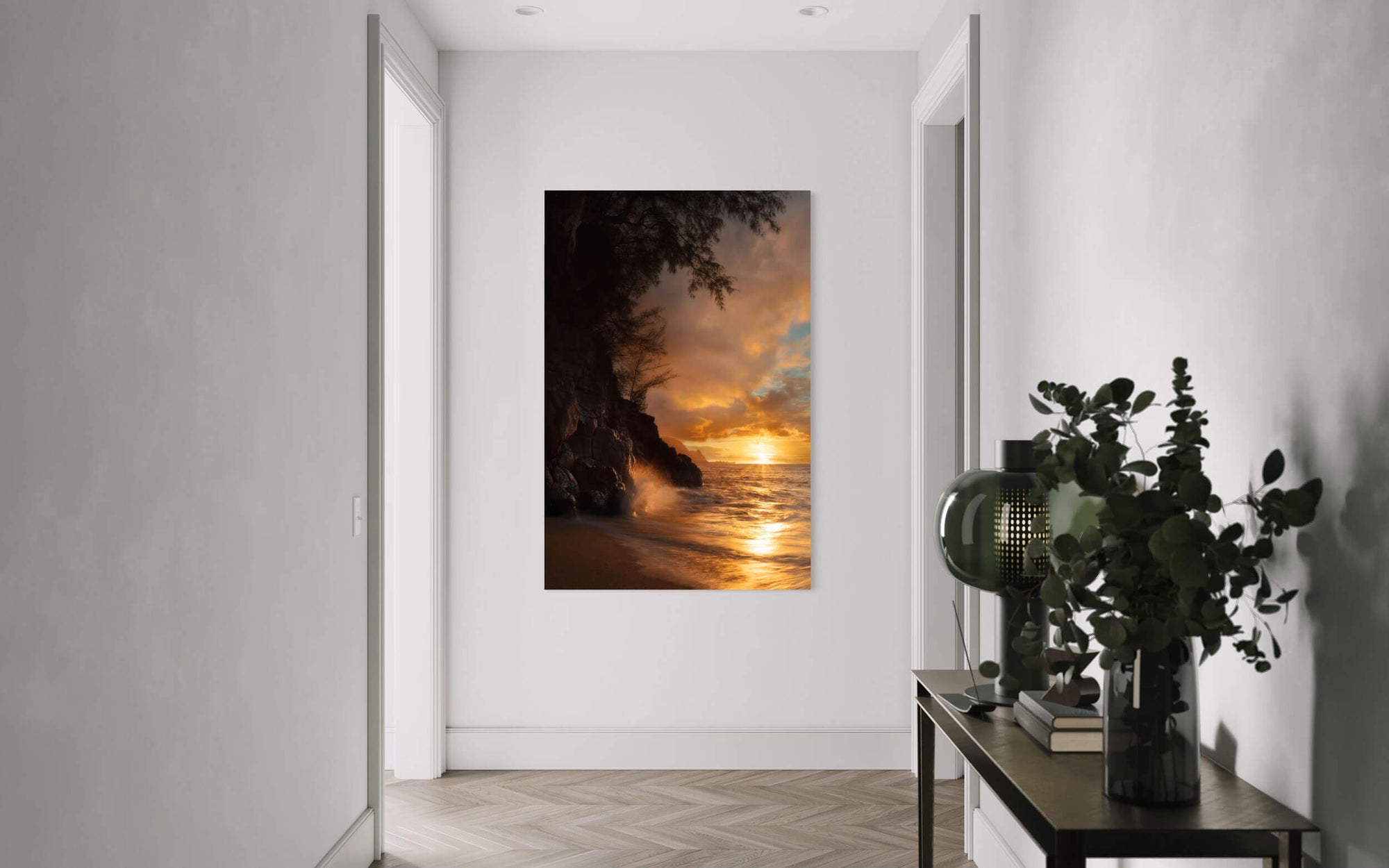 A piece of Kauai art showing a sunset picture from Hideaway Beach hangs in a hallway.