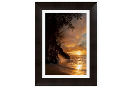 This piece of framed Kauai art shows a sunset picture from Hideaway Beach.