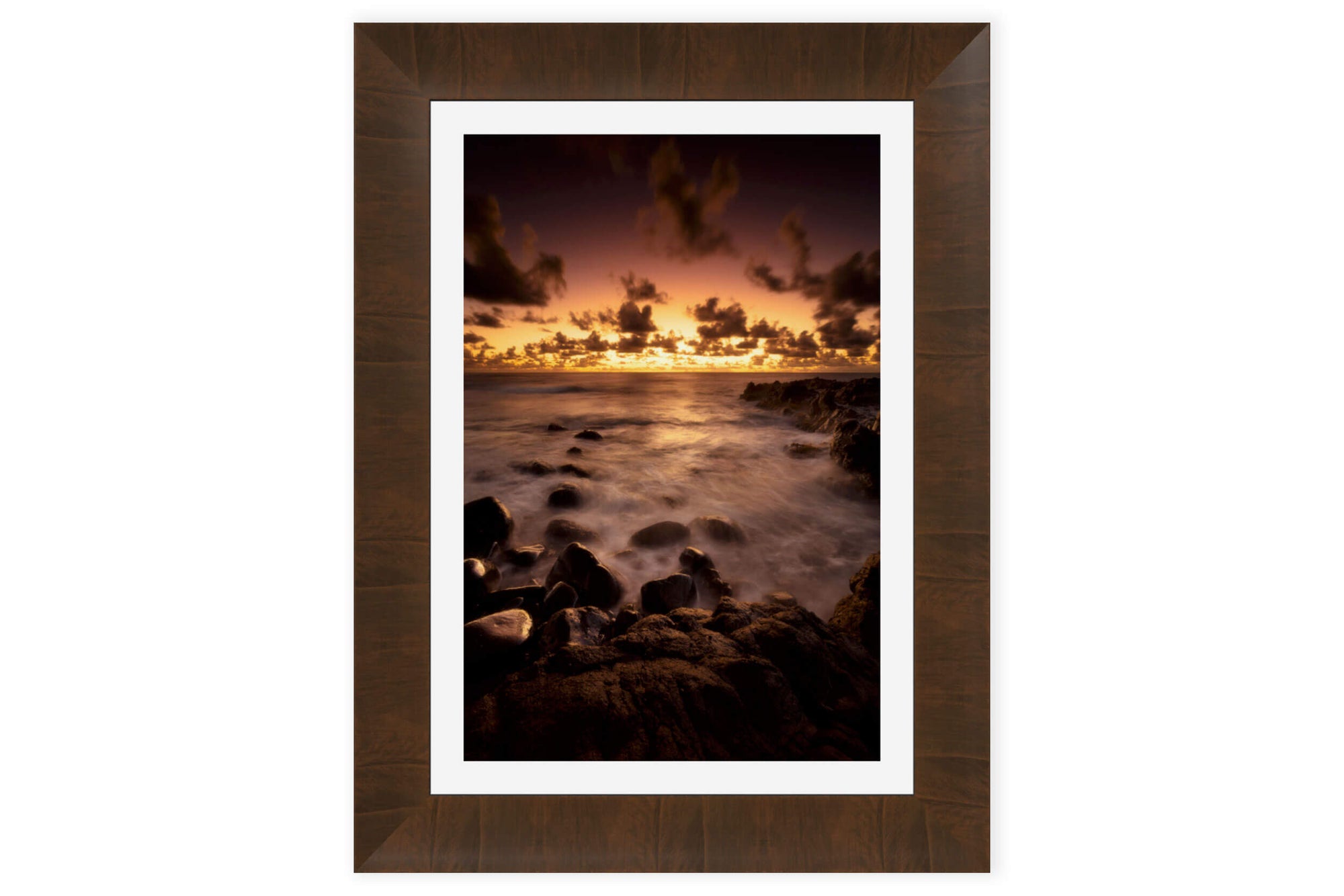 A piece of framed Kauai art shows a Kapaa sunrise picture.