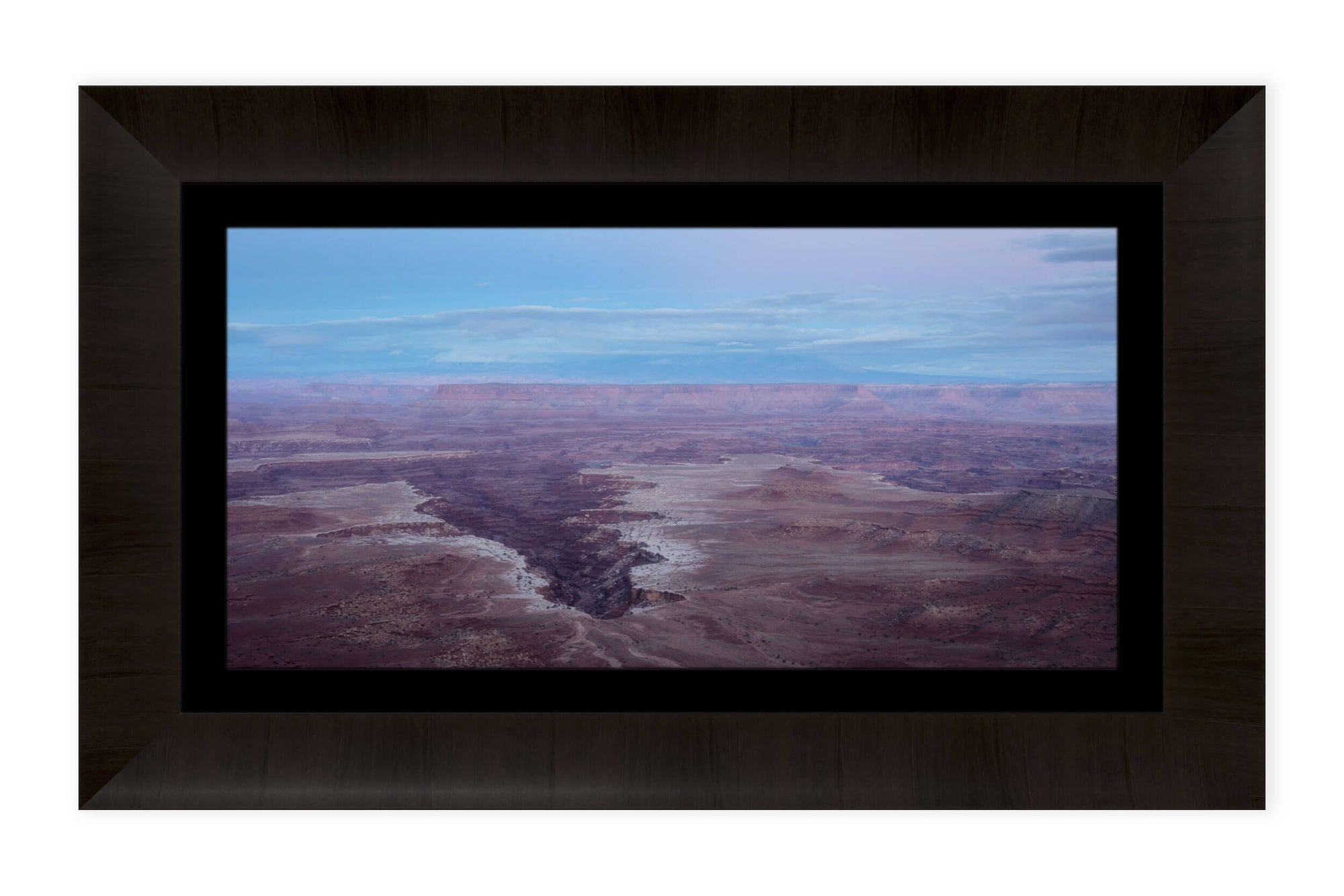 A piece of framed Moab art shows a Canyonlands National Park picture at sunset.