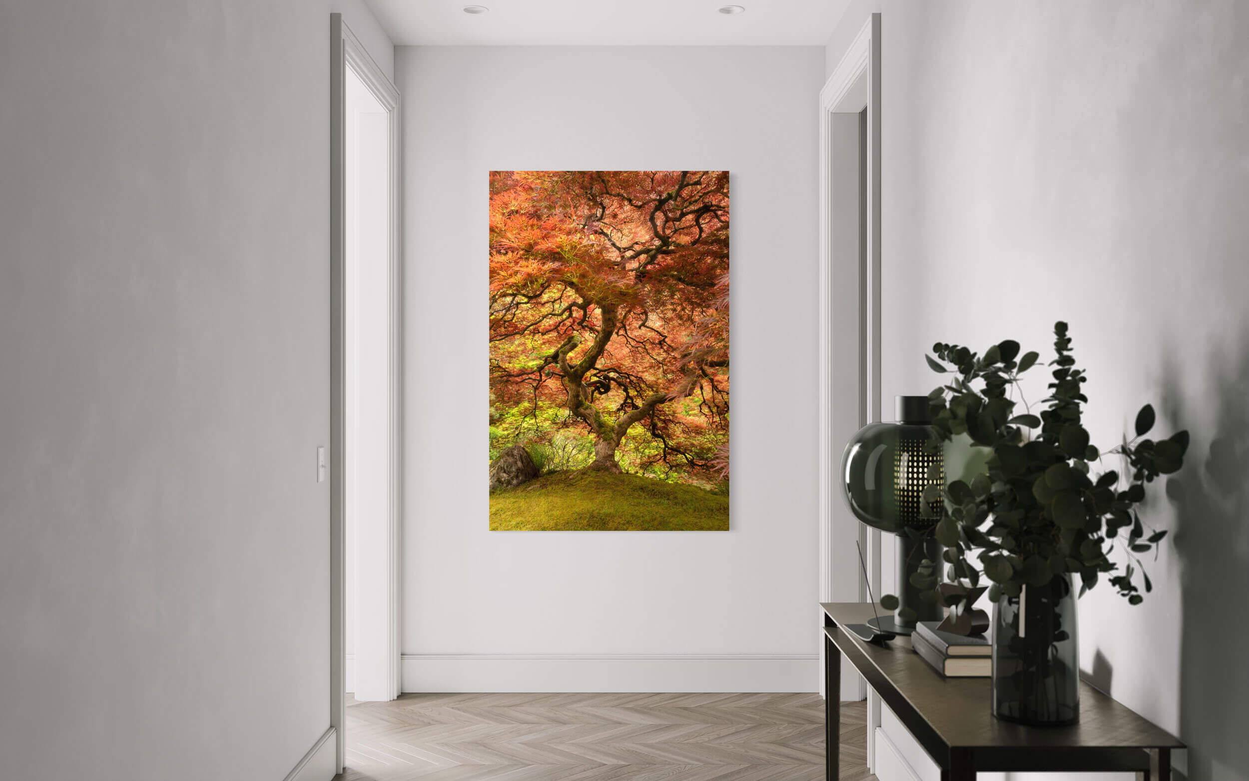 A piece of Japanese Garden art showing a maple tree hangs in a hallway.