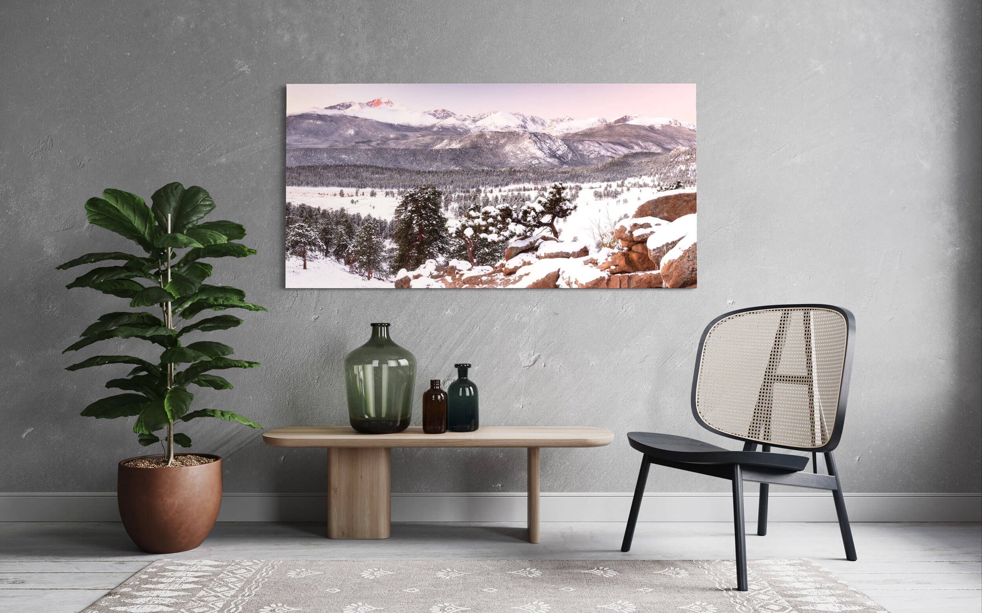 A piece of Rocky Mountain National Park art showing a sunrise hangs in a living room.