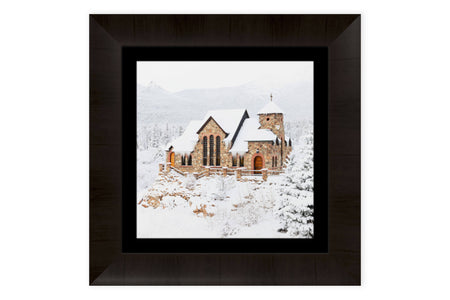 A piece of framed Colorado art shows St. Malo's Chapel near Estes Park.