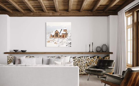 A piece of Colorado art showing St. Malo's Chapel near Estes Park hangs in a living room.