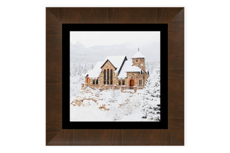 A piece of framed Colorado art shows St. Malo's Chapel near Estes Park.