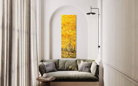 A piece of Telluride art showing an aspen tree during fall in Telluride hangs in a living room.