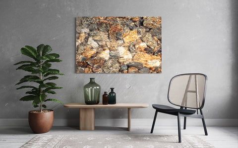 A piece of Telluride art showing glistening rocks in a Colorado River hangs in a living room.