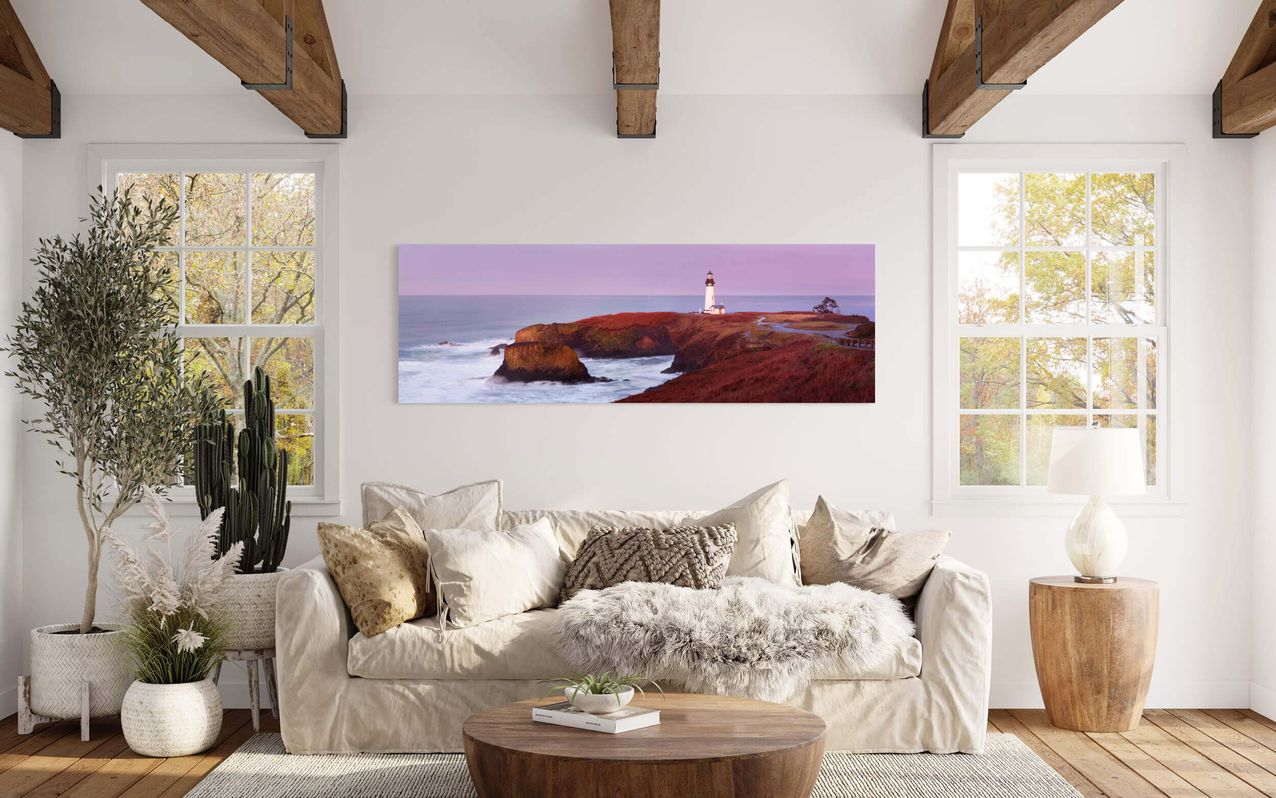 A piece of Oregon art showing the Yaquina Head Lighthouse in Oregon hangs in a living room.